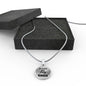 Dream Big Pray Bigger necklace laying on a black box.